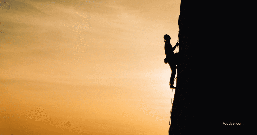 Hardest physical sport to learn - Climber scaling a challenging rock face, showcasing physical and mental strength