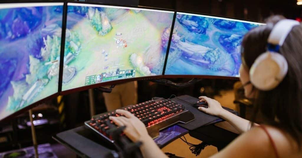 Gordon Hayward, NBA star, playing League of Legends on his gaming setup, showcasing his transition from basketball to esports.